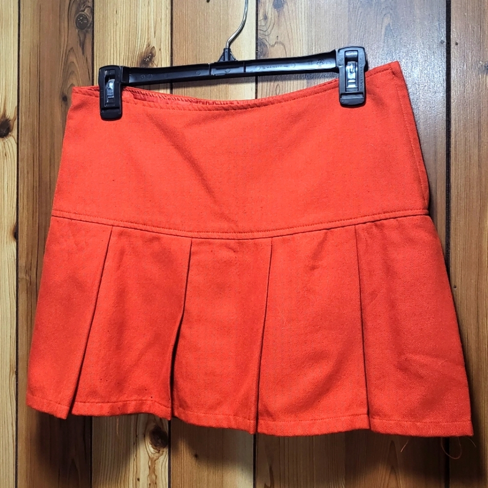 orange pleated miniskirt